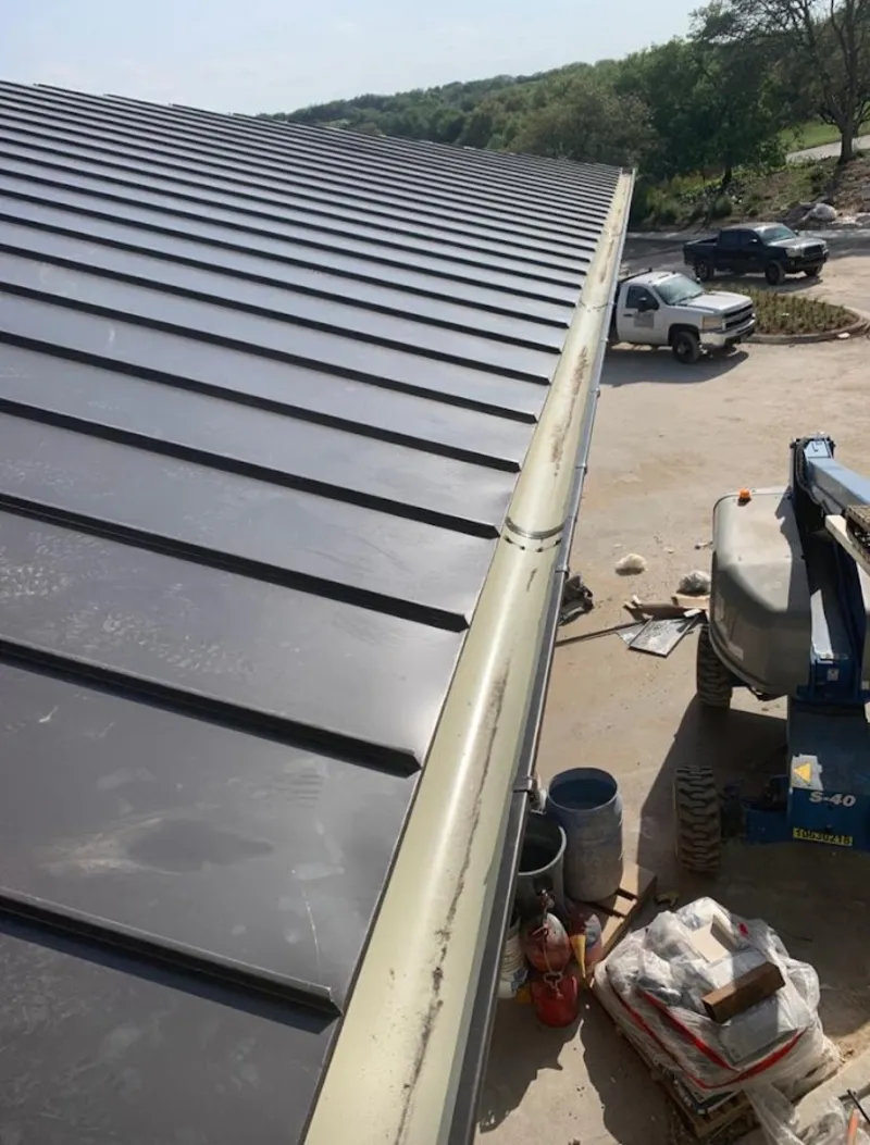 Standing seam panel and gutter detail on a metal roofing jobsite in Hopewell
